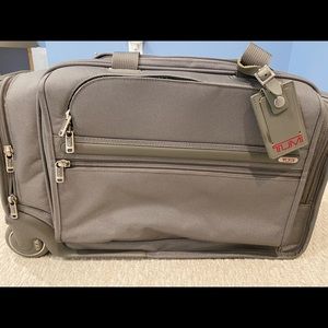 Tumi roller travel bag. 22x10x12. May not fit carry on overhead.